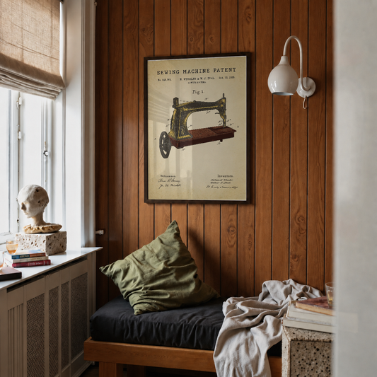 Sewing machine patent print framed above a bed in a bedroom