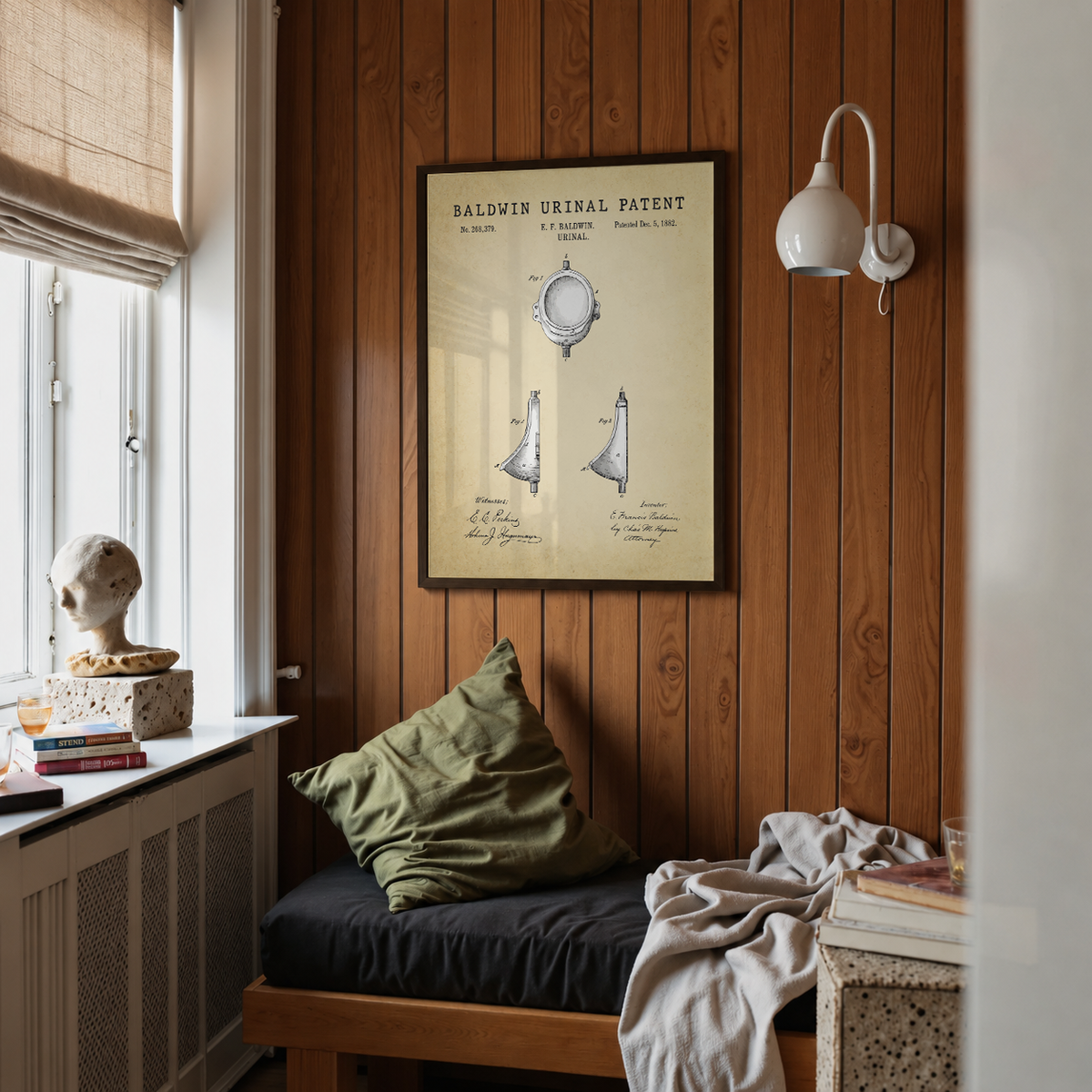 Baldwin urinal patent print framed above a bed in a bedroom