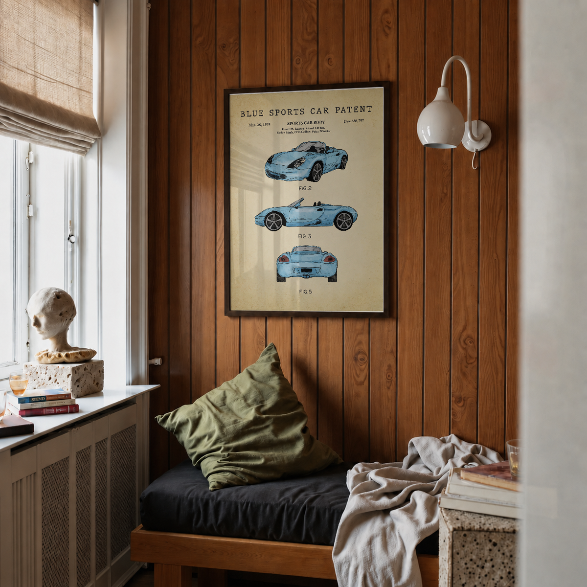 Blue sports car patent print framed above a bed in a bedroom