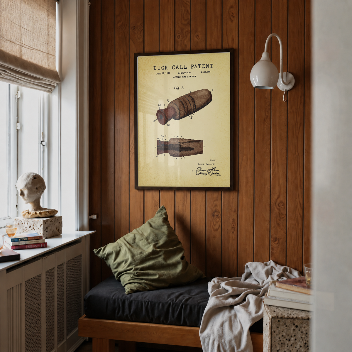 Duck call patent print framed above a bed in a bedroom