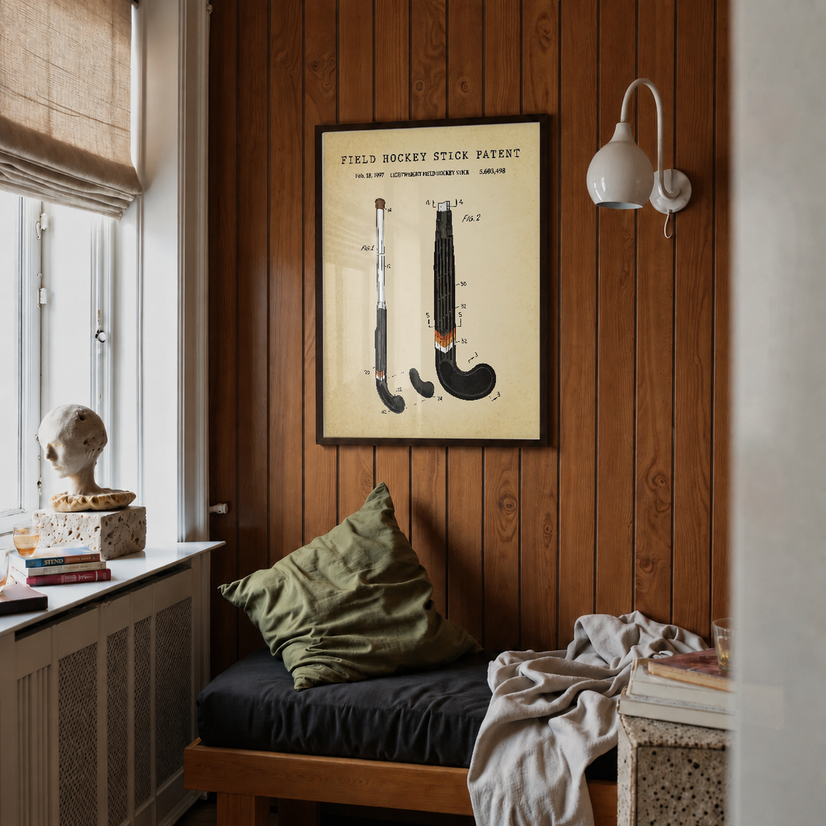 Field hockey stick patent print framed above a bed in a bedroom