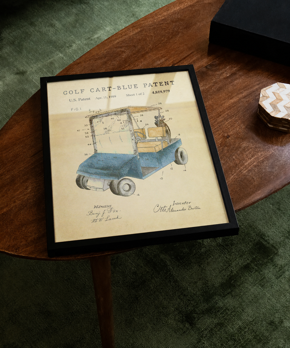 Blue golf cart patent print displayed on a tabletop