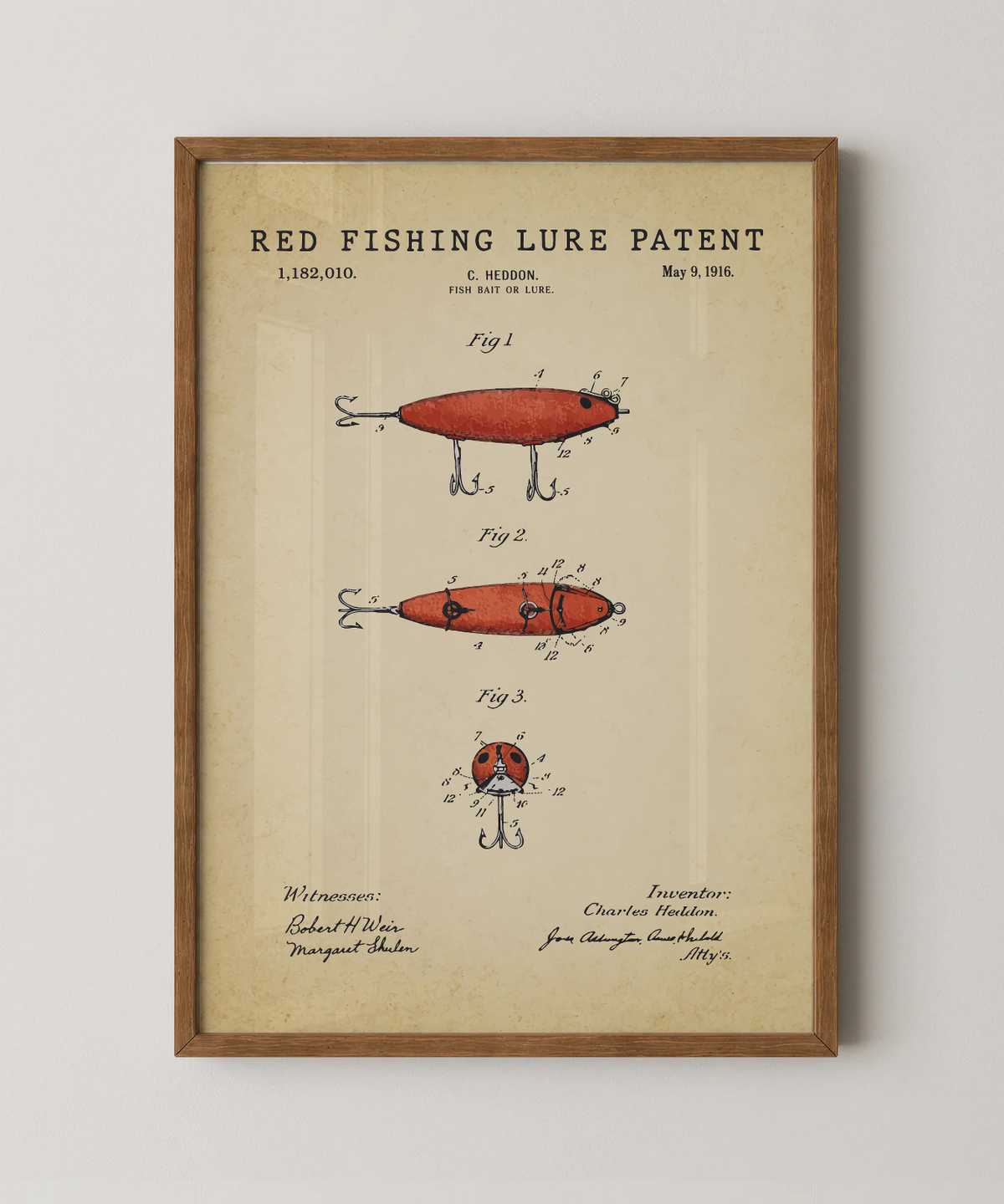 Red fishing lure patent print in a natural oak wood frame